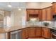 A kitchen featuring wood cabinets, granite countertops, and stainless steel appliances at 5250 Villa Lake Ct, Suwanee, GA 30024