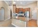 Open kitchen with granite countertops, stainless steel appliances, and wood cabinets at 5250 Villa Lake Ct, Suwanee, GA 30024