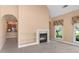 Living room with a fireplace, built-in shelves, and access to the kitchen at 5250 Villa Lake Ct, Suwanee, GA 30024