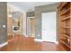 Spacious living room with hardwood floors, built-in bookshelf, and a fireplace in the background at 5250 Villa Lake Ct, Suwanee, GA 30024