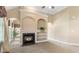 Bright and open living room with a fireplace, built-in shelves, and neutral carpeting at 5250 Villa Lake Ct, Suwanee, GA 30024