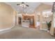 Open-concept living area flows into the kitchen, featuring neutral tones and abundant natural light at 5250 Villa Lake Ct, Suwanee, GA 30024