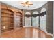 Bright living room with hardwood floors, built-in bookcase, and decorative bay windows at 5250 Villa Lake Ct, Suwanee, GA 30024