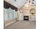 Bright living room featuring a fireplace, built-in shelves, and large windows with shutters at 5250 Villa Lake Ct, Suwanee, GA 30024