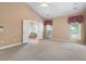 Spacious carpeted main bedroom with doors that lead to the main bathroom at 5250 Villa Lake Ct, Suwanee, GA 30024