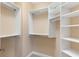 Spacious walk-in closet with custom shelving and ample storage space at 5250 Villa Lake Ct, Suwanee, GA 30024