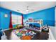 A bedroom features a playful sports themed rug, bunkbeds, and lots of light from the window at 771 Arbor Gate Ln, Lawrenceville, GA 30044