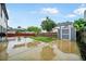 Large backyard with a concrete patio, storage shed, mature trees, and a wooden fence at 773 Minor Oaks Nw Run, Lilburn, GA 30047
