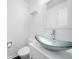This powder room has a modern bowl sink, sleek faucet, and a white vanity at 773 Minor Oaks Nw Run, Lilburn, GA 30047