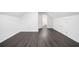 This room features dark wood-look floors, white walls and trim, and an attic ceiling at 773 Minor Oaks Nw Run, Lilburn, GA 30047