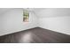 Attic bedroom with a slanted ceiling, window, and hardwood floor at 773 Minor Oaks Nw Run, Lilburn, GA 30047