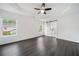 Bright bedroom featuring modern tray ceilings, a ceiling fan and an ensuite bathroom with sliding barn door at 773 Minor Oaks Nw Run, Lilburn, GA 30047