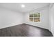 This bedroom has a window offering a view, sleek floors, and a closet with double doors at 773 Minor Oaks Nw Run, Lilburn, GA 30047
