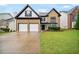 Attractive two-story home featuring a two-car garage, brick facade, and well-kept lawn at 773 Minor Oaks Nw Run, Lilburn, GA 30047