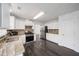 Spacious kitchen with stainless steel appliances, granite countertops, and a mosaic backsplash at 773 Minor Oaks Nw Run, Lilburn, GA 30047