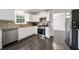 Well-lit kitchen featuring modern appliances, granite countertops, and lots of storage at 773 Minor Oaks Nw Run, Lilburn, GA 30047
