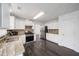 Updated kitchen features stainless appliances, granite countertops, and ample cabinet space at 773 Minor Oaks Nw Run, Lilburn, GA 30047
