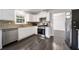 Bright kitchen with granite countertops, stainless steel appliances, and modern finishes at 773 Minor Oaks Nw Run, Lilburn, GA 30047