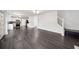 Spacious living room with dark wood-look floors, fireplace, and open to kitchen at 773 Minor Oaks Nw Run, Lilburn, GA 30047