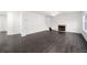 Open-concept living room with dark wood-look flooring, fireplace, and a staircase at 773 Minor Oaks Nw Run, Lilburn, GA 30047