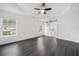 Bright main bedroom with dark floors, ceiling fan, tray ceiling, and sliding barn door to ensuite bathroom at 773 Minor Oaks Nw Run, Lilburn, GA 30047