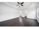 Main bedroom features tray ceiling, ceiling fan, and modern floors at 773 Minor Oaks Nw Run, Lilburn, GA 30047