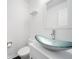 Powder room features a modern sink with an elegant glass bowl at 773 Minor Oaks Nw Run, Lilburn, GA 30047