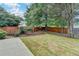 Expansive backyard features a wooden swing set and a newly installed lawn at 12060 Carriage Park Ln, Duluth, GA 30097