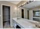 Bathroom features an expansive mirror, long vanity with dual sinks, and walk-in closet at 12060 Carriage Park Ln, Duluth, GA 30097