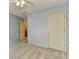 This bedroom includes neutral walls and carpet, plus a ceiling fan and a double door closet at 12060 Carriage Park Ln, Duluth, GA 30097