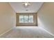 Bright and spacious bedroom with vaulted ceilings, large window, and plush carpet at 12060 Carriage Park Ln, Duluth, GA 30097