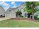 Lovely two-story home with mature trees, green lawn and a two-car garage at 12060 Carriage Park Ln, Duluth, GA 30097