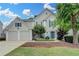 Beautiful two-story home featuring a well-maintained lawn and a two-car garage at 12060 Carriage Park Ln, Duluth, GA 30097