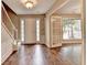 Inviting foyer with hardwood floors and stairs at 12060 Carriage Park Ln, Duluth, GA 30097
