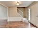 Bright foyer featuring hardwood floors, a staircase and a front door at 12060 Carriage Park Ln, Duluth, GA 30097