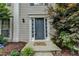 Charming front entrance with decorative door and well-manicured landscaping at 12060 Carriage Park Ln, Duluth, GA 30097