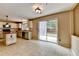 Bright kitchen with tile flooring, an island and sliding glass doors leading to the backyard at 12060 Carriage Park Ln, Duluth, GA 30097