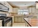 Well-lit kitchen features modern appliances, tile backsplash, and ample counter space at 12060 Carriage Park Ln, Duluth, GA 30097
