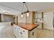 Spacious kitchen island with wooden countertop and cabinet storage at 12060 Carriage Park Ln, Duluth, GA 30097