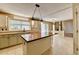 Open-concept kitchen and living room with island and natural light at 12060 Carriage Park Ln, Duluth, GA 30097