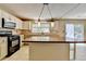 Modern kitchen with black appliances, tile backsplash, and a sliding glass door leading outside at 12060 Carriage Park Ln, Duluth, GA 30097