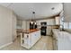 Eat-in kitchen boasts white cabinets, black appliances, and a center island with wood countertop at 12060 Carriage Park Ln, Duluth, GA 30097
