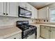 Updated kitchen with stainless steel appliances, tiled backsplash, and neutral countertop at 12060 Carriage Park Ln, Duluth, GA 30097