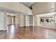 Spacious living room with hardwood floors and an open layout, connecting seamlessly to the entry and kitchen at 12060 Carriage Park Ln, Duluth, GA 30097