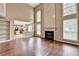 Spacious living room with hardwood floors, fireplace, and open layout to the kitchen, perfect for entertaining at 12060 Carriage Park Ln, Duluth, GA 30097