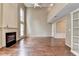 Bright living room with hardwood floors, a fireplace, and ample natural light, perfect for relaxing or entertaining at 12060 Carriage Park Ln, Duluth, GA 30097
