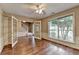Bright living room with hardwood floors, large windows, and glass panel doors at 12060 Carriage Park Ln, Duluth, GA 30097