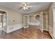Inviting living room with hardwood floors, detailed wainscoting and a ceiling fan creates an inviting space at 12060 Carriage Park Ln, Duluth, GA 30097