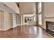 Inviting living room shows hardwood floors and views of the kitchen, creating an open and airy living space at 12060 Carriage Park Ln, Duluth, GA 30097
