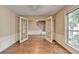 Spacious living room with hardwood floors, large window, and glass panel doors at 12060 Carriage Park Ln, Duluth, GA 30097